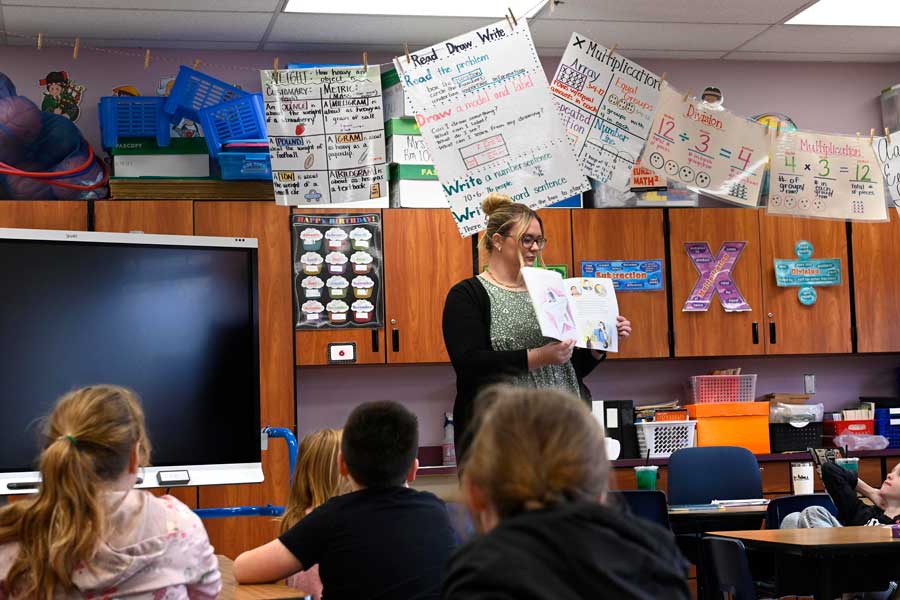 Student teacher reading to students