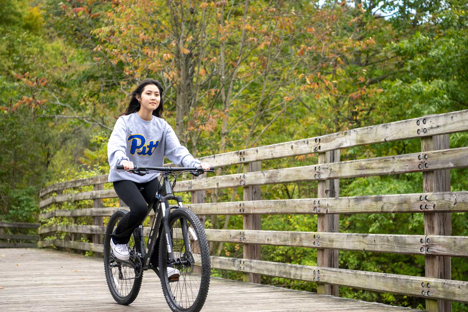 Student biking on Trail