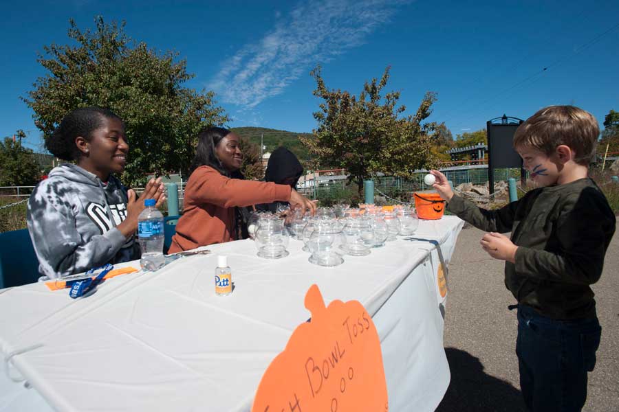 Students working a table in the Kid Zone at Pumpkinfest