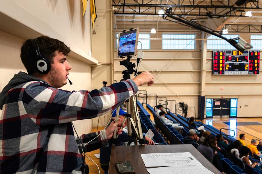 A student operating a livestream for a sporting event