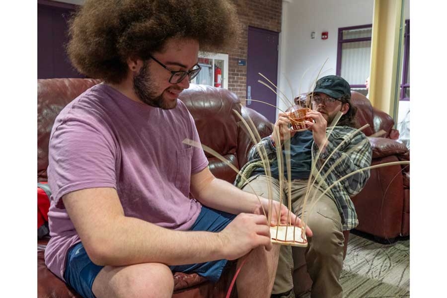 some students working on weaving together a basket
