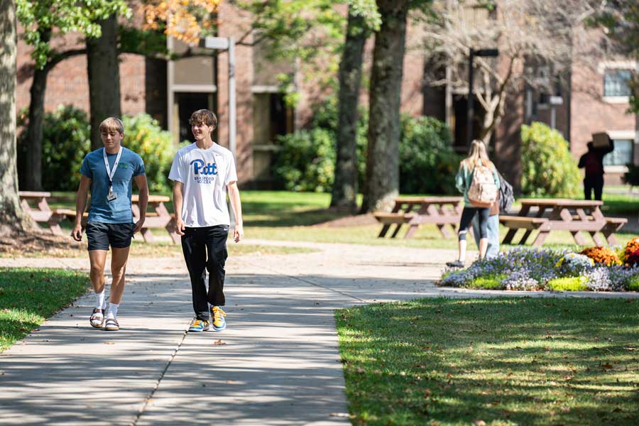 two students walking through the quad