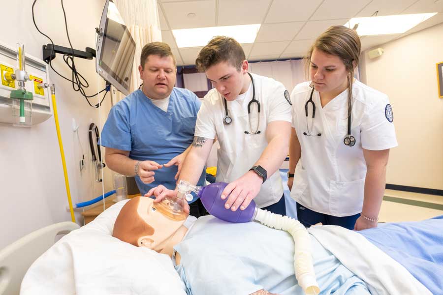 nursing students practicing on a dummy