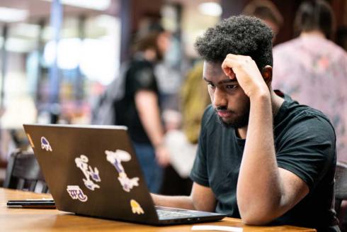 Student using laptop in the library