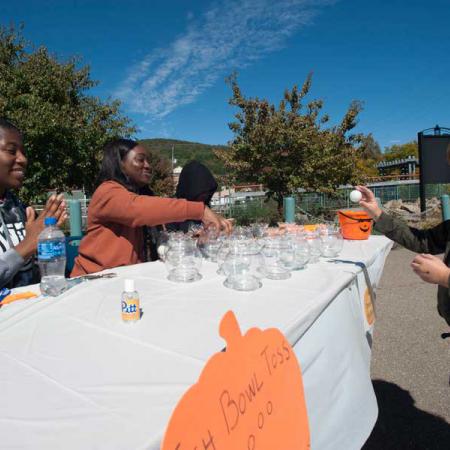 Students working a table in the Kid Zone at Pumpkinfest